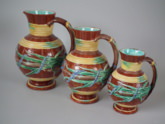 Set of 3 Wedgwood Majolica ribbon & bulrush pitchers