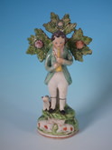 Staffordshire Pearlware piper with dog&sheep figure