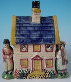 Staffordshire Prattware money box cottage