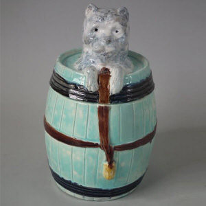 Majolica dog in barrel tobacco jar & cover